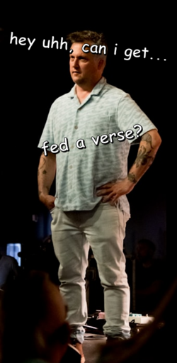 a man standing on a stage with his hands on his waist looking slightly dismayed. white text along the top and the center says, "hey uhh, can i get...fed a verse?"