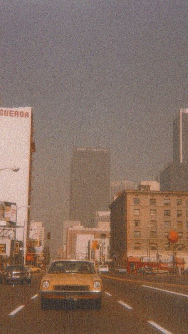 Yellow car driving in a smoggy city