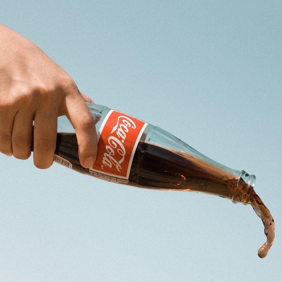 Coca-Cola bottle being poured out