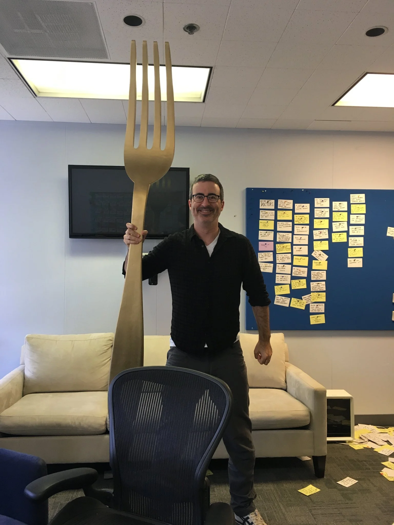 photo of John Oliver holding a giant fork