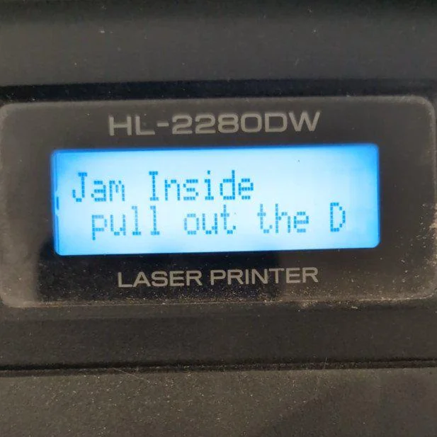 A printer screen that says "Jam inside, pull out the D"