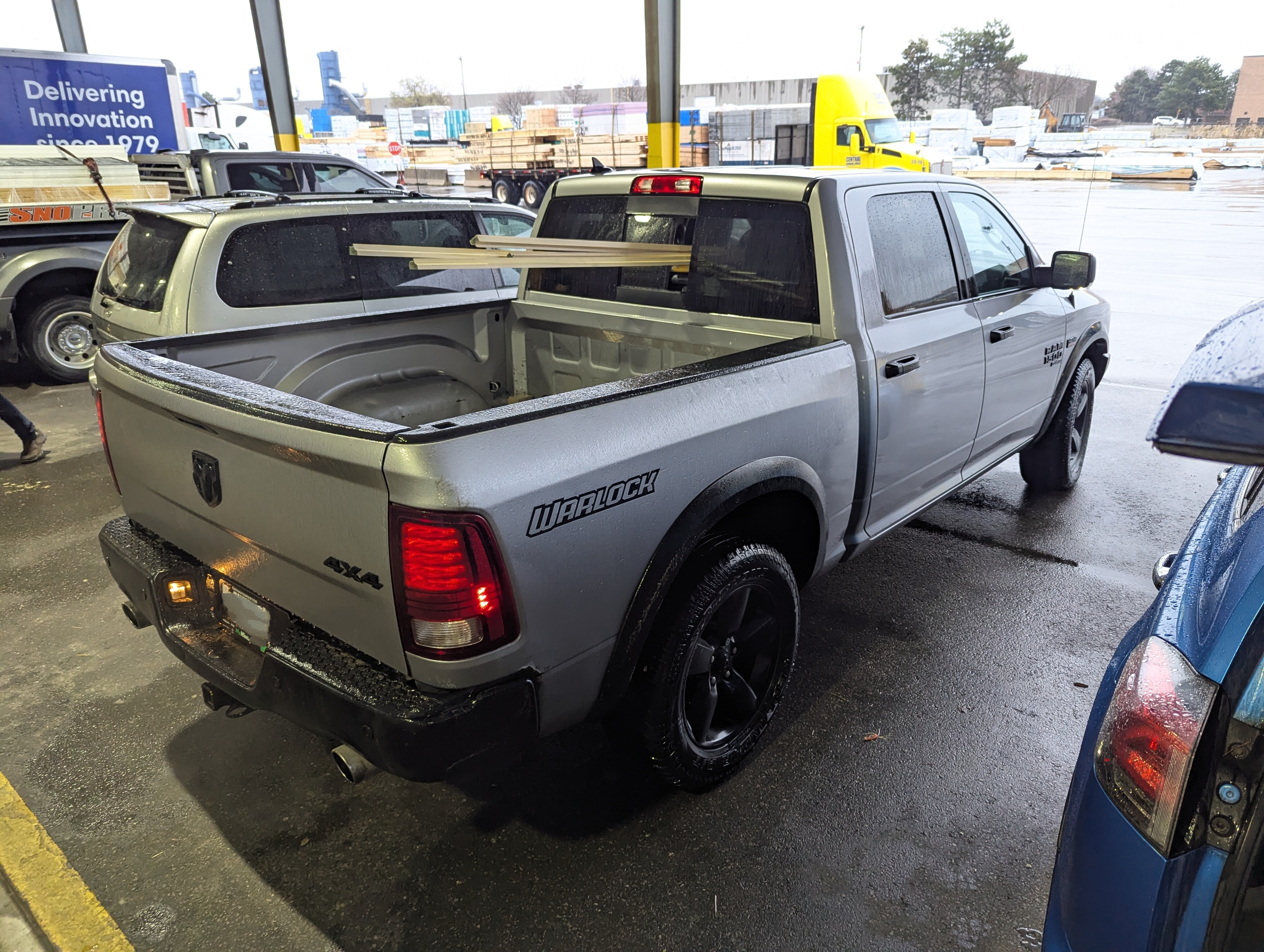 Truck loading lumber through cab back window because bed is too small