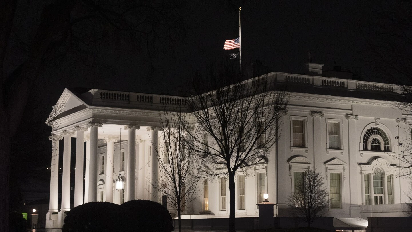 Why are US flags being flown at half-staff on Inauguration Day?