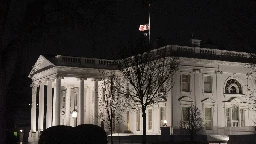 Why are US flags being flown at half-staff on Inauguration Day?