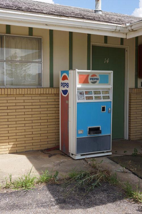 Pepsi machine in front of a motel