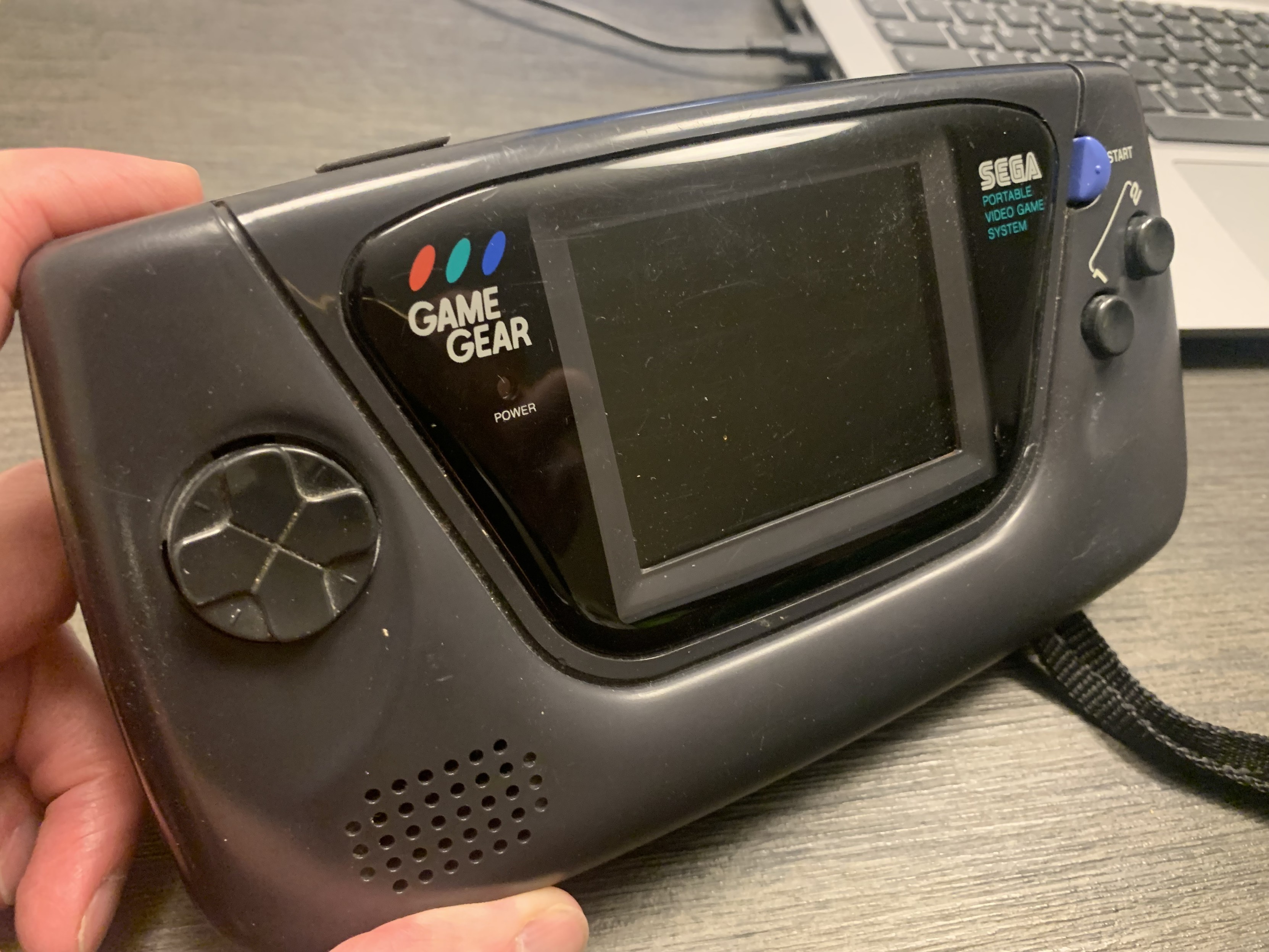 An all black SEGA GameGear handheld console. 