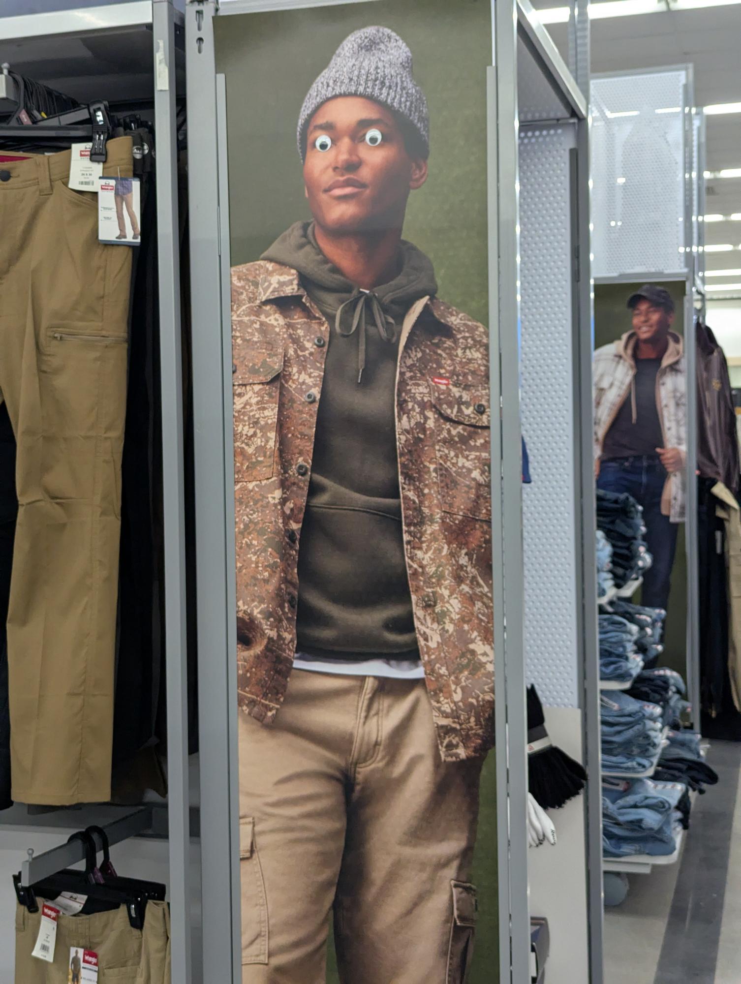 image of a man in a clothing advertisement, but he has googly eyes