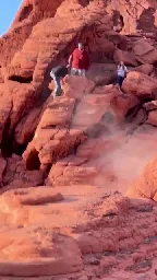 Two guys destroying rocks at a protected National Park.