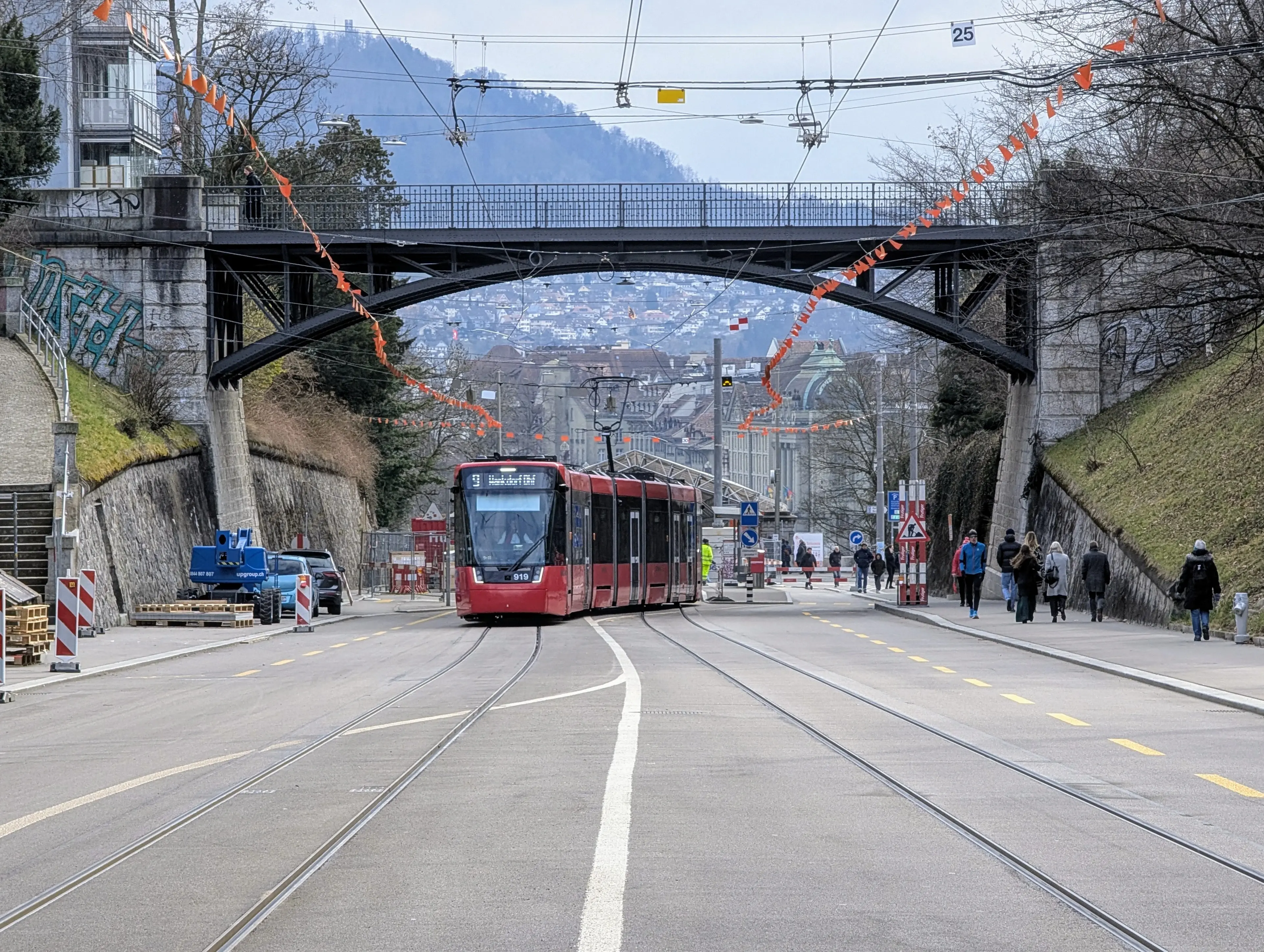 A red tram switching direction in Bern Switzerland. in background a part of the city